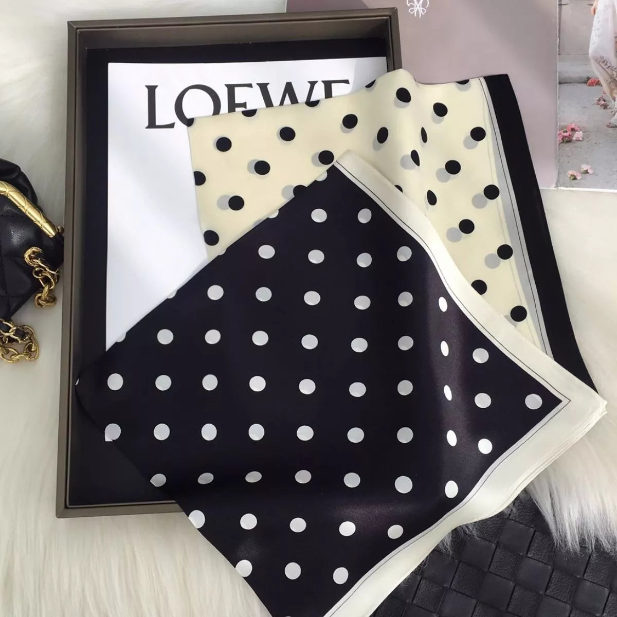 Black and cream white polka dot silk scarves displayed together with contrasting borders
