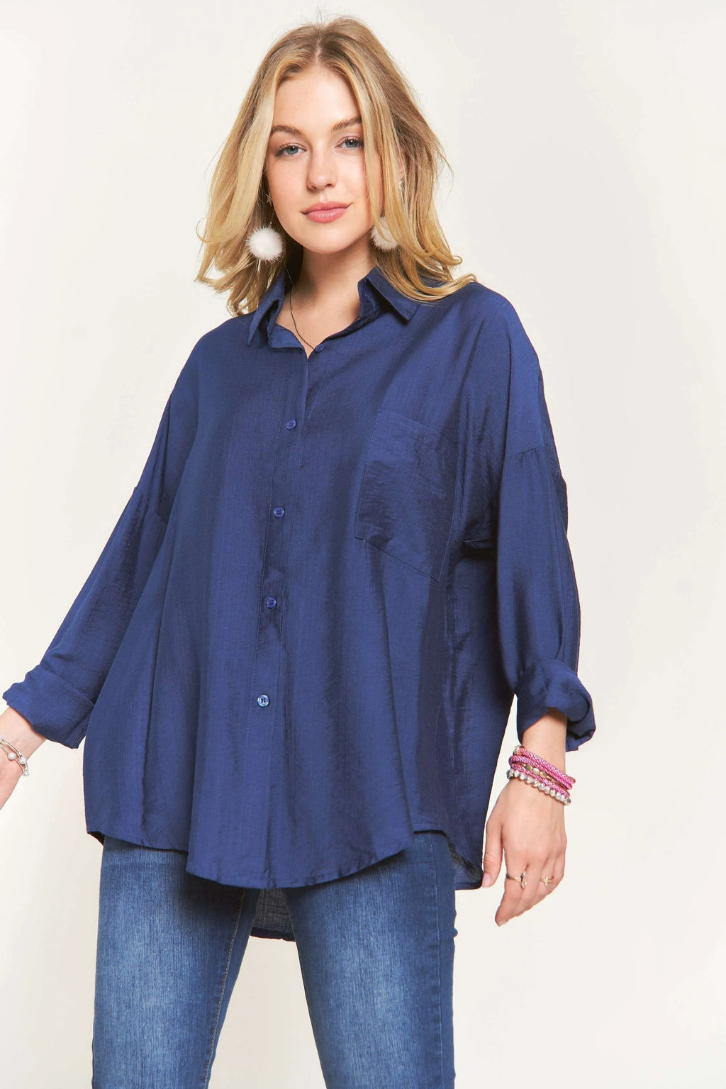 "Model walking in the ADORA navy linen button-down shirt, full-length front view"