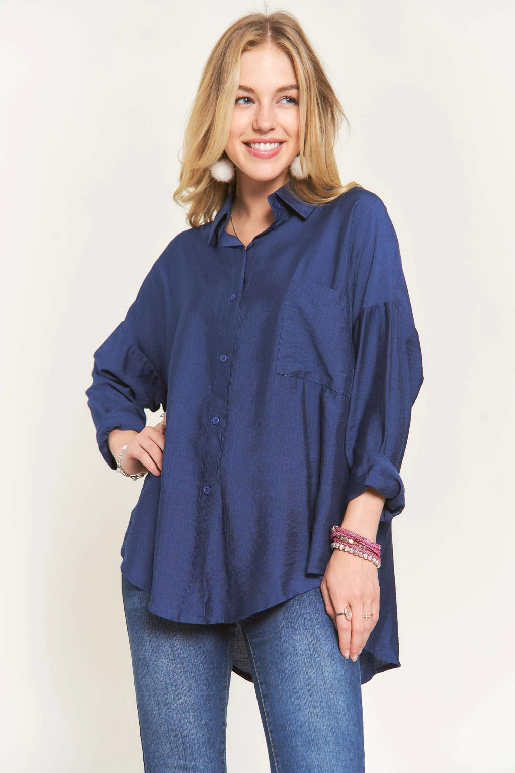 "Model wearing the ADORA navy linen button-down shirt with white jeans, front view"