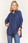 "Model wearing the ADORA navy linen button-down shirt with white jeans, front view"