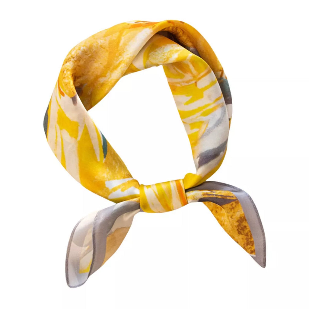 Sherbet yellow floral square scarf tied in a loop against a white background.