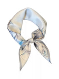 Light gray floral square scarf tied in a loop against a white background.